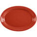 A red oval Fiesta china platter with a rim.