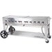 A large stainless steel Crown Verity portable outdoor BBQ grill with four burners.