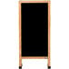 An Aarco oak A-frame sign board with a black marker board and wooden legs.
