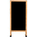 An Aarco oak A-frame sign board with a black marker board and wooden frame.