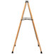 An Aarco oak A-Frame sign board with black marker board on a wooden easel with metal legs.