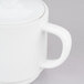 A white Arcoroc stackable teapot with a lid and handle.
