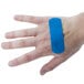 A person wearing a blue Medique adhesive strip bandage on their hand.