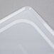 A translucent plastic lid with handles on a white background.