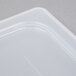 A close up of a translucent white plastic lid with handles.