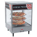 A Nemco three tier rack system with pizza displayed on it.