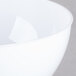 A close-up of a Fineline white plastic bowl.
