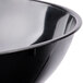 A close-up of a black Fineline plastic bowl.