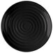 A black melamine round plate with a white spiral design.