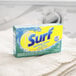 A box of Surf Sparkling Ocean Powder Laundry Detergent on a counter.