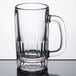 A clear glass Libbey beer mug with a handle.