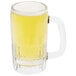 A Libbey glass beer mug filled with beer and foam.