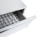 A stainless steel drawer for an APW Wyott hot dog bun warmer with a grate on top.