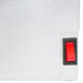 A close up of a red switch on a stainless steel APW Wyott bun warmer box.