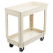A beige plastic utility cart with two shelves and wheels.