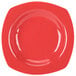 A close up of a red square pasta bowl with a white background.