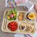 A Carlisle tan school lunch tray with food in it.