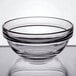 An Arcoroc clear glass bowl with a clear rim.