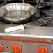 A Victorinox slotted fish, egg, and chef's spatula on a stove.