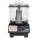 A black Waring food processor with a clear plastic lid.