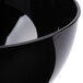 A close up of a black Fineline plastic bowl.