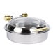 A Vollrath stainless steel round chafing dish with brass and glass lid.