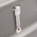 A close-up of a thermometer in an APW Wyott drop-in cold well.