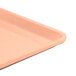 A close up of a dark peach rectangular plastic Cambro dietary tray.