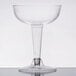 A clear plastic Fineline Flairware champagne glass with a stem and clear base.