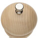 A close-up of a Chef Specialties wooden pepper mill with a silver knob.