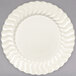 A white Fineline plastic plate with a wavy edge.