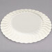 A white Fineline Flairware plastic plate with scalloped and wavy edges.
