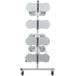 A white metal Bulman horizontal paper rack with three shelves holding several round paper rolls.