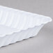 A white plastic tray with wavy edges.