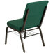A green church chair with a gold metal frame and dot patterned fabric.