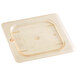 A Cambro H-Pan 1/6 size amber plastic lid on a plastic container.