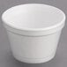 A Dart white styrofoam food container with a lid.