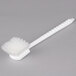 A white brush with bristles and a white plastic handle.