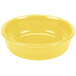 A close up of a Fiesta Sunflower small china bowl with a yellow surface.