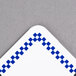 A white square deli tag with a blue checkered border.