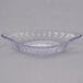 A clear glass banana split dish with a round rim on a white background.