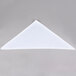 A white folded triangle chef neckerchief on a gray surface.