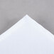 A folded white Intedge chef neckerchief with a corner showing.