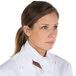 A woman wearing a white chef neckerchief.