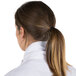 A woman with a ponytail wearing a white Intedge chef neckerchief.