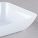 A white rectangular plastic tray with a white surface.