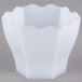 A close-up of a white Fineline hexagon cube bowl.