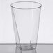 A clear plastic Fineline square bottom tumbler on a table.