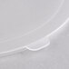 A close-up of a Fineline clear plastic bowl flat lid with a small hole in it.