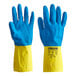 A pair of blue and yellow rubber gloves with a yellow band on the blue glove.